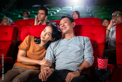 Photography Happy trip of asian couple sweet sit togather on red seat and looking  movie in