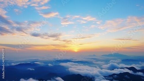 view above the clouds. yellow and blue sky above clouds sunrise. Sunset sky background with realistic small clouds.. Generative AI © @adha