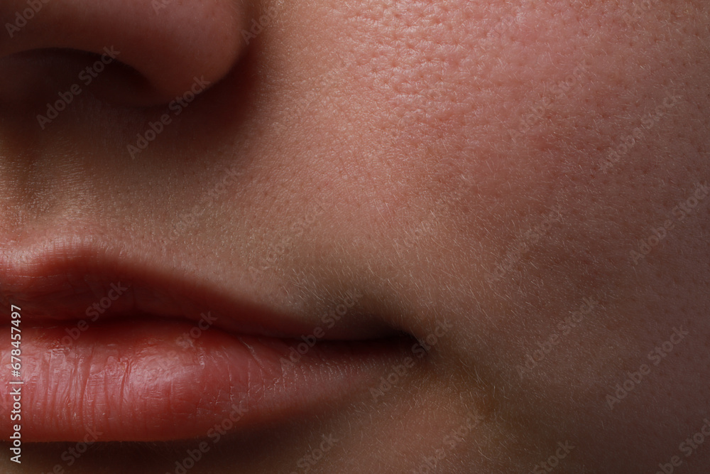 Closeup view of woman with normal skin and beautiful lips Closeup view of woman with normal skin and beautiful lips