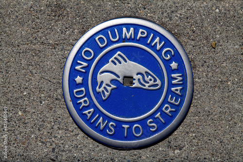 Metal No Dumping Sign In Sidewalk Warning