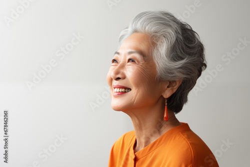 Side view of senior asian woman smile studio shoot