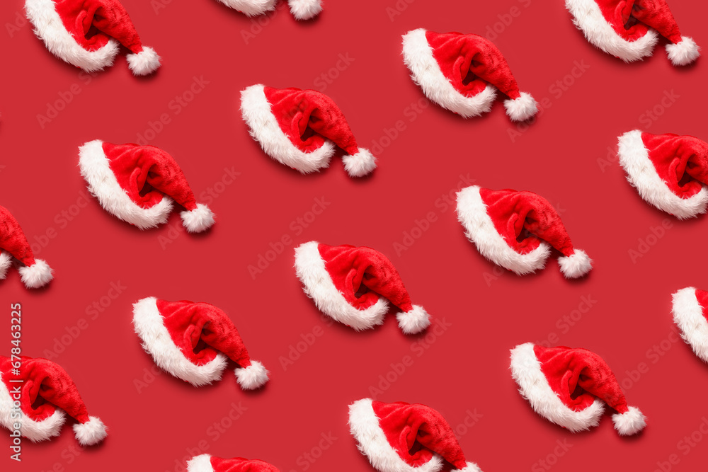 Many Santa hats on red background. Pattern for design Many Santa hats on red background. Pattern for design
