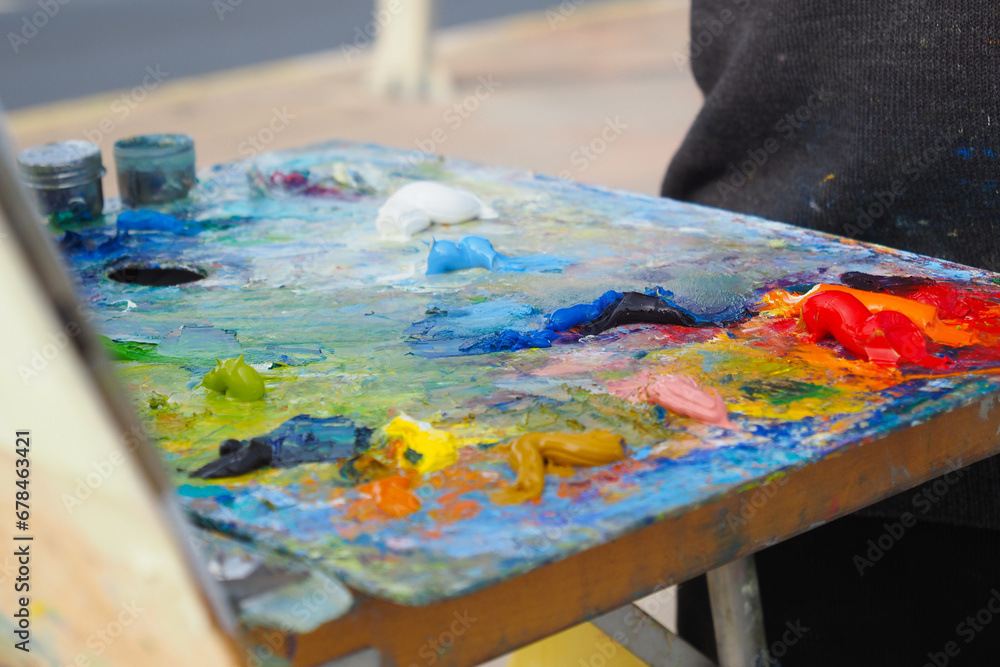 Colorful palette with oil painting and brushes Colorful palette with oil painting and brushes