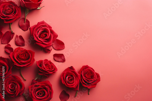 Red roses over a pink background flat lay. Valentine s Day  Birthday abstract background with copy space