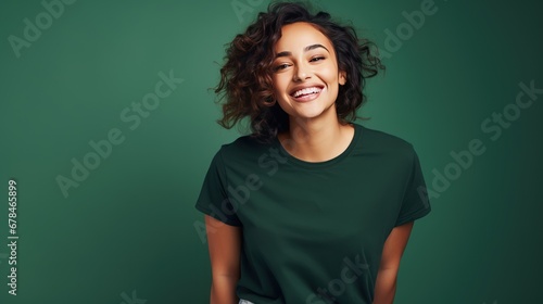 Portrait of funny young lady dressed casual t-shirt smiling on dark green background. © CStock