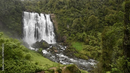 Marokopa Falls in thick forest in the Waitomo area of the Waikato Region, New Zealand. Here the Marokopa River cascades over the undercut greywacke basement rock.
