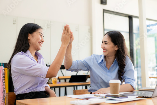 Happy, excited, success in business, Asian woman wins in office, beautiful Asian woman celebrates with laptop. happy success gesture ecommerce