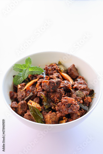 Kerala style beef or Mutton dry fry. delicious spicy Beef fry in clay pot . beef curry for ghee rice, kappa, appam, parotta, puttu, bread and chappathi, beef roast. Indian cuisine .