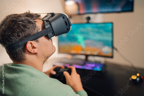 Addicted gamer using virtual reality goggles to play at home