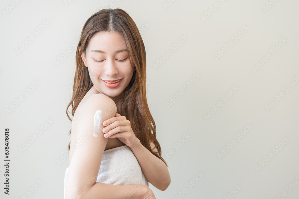Health care, beauty asian young woman, girl wrapped in towel after shower bath, spa relax at home, hand applying, putting moisturizing lotion on her shoulder. Skincare routine in the morning. Health care, beauty asian young woman, girl wrapped in towel after shower bath, spa relax at home, hand applying, putting moisturizing lotion on her shoulder. Skincare routine in the morning.