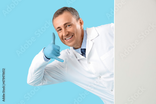 Mature doctor with blank po...