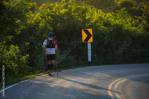 A runner is tired from running uphill in an ultra race. photo