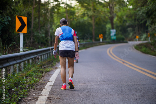 A runner is tired from running uphill in an ultra race.