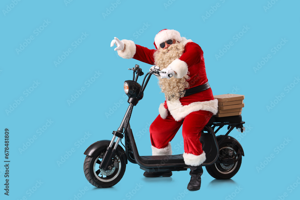 Santa Claus with pizza boxes on bike against blue background Santa Claus with pizza boxes on bike against blue background