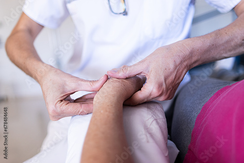 Focused photo of a female doctor hands massaging her patient hands while they are in the clinic.