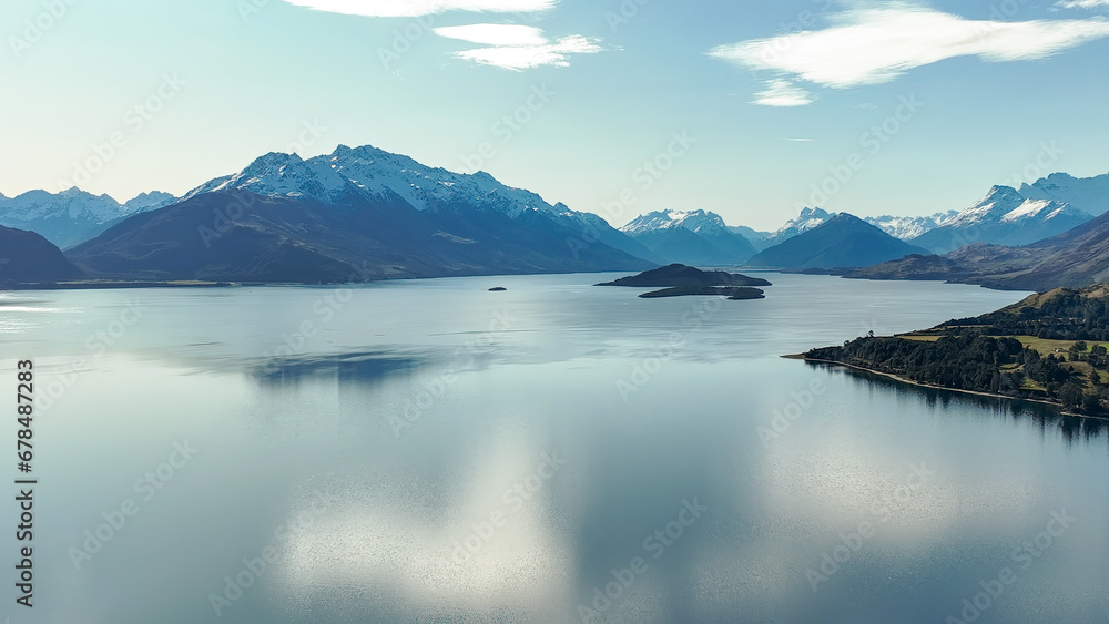 Dreamy aerial view from a mavic drone of the shoreline  of lake Wakatipu and its surrounding mountain ranges