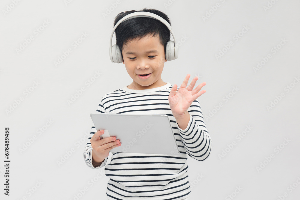Young boy plays with his tablet isolated on white background Young boy plays with his tablet isolated on white background