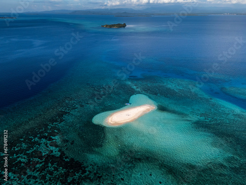 Dodola Island, one of the most beautiful places to go in Morotai, one of the island on North Maluku, Indonesia. Dodola island is divided into 2 island and it will connected the the sea tide is low .  photo