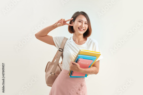 Portrait of smiling young woman student in shirt backpack hold notebooks.