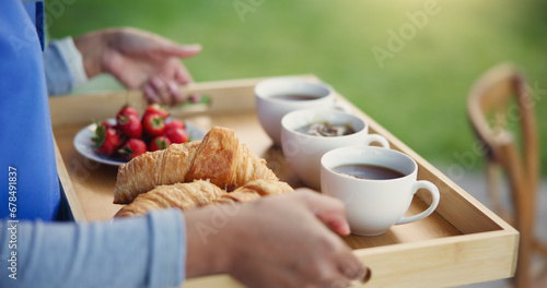 Food, breakfast and tray for morning, tea and fruit, pastry and crossiants, strawberry and nutrition. Healthy living, fiber and beverage for thirst, coffee and nurse to serve, meal and backyard photo