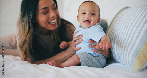 Family, smile and a mother on the bed with her baby in their home together for care or bonding. Children, love and a happy young woman in the bedroom of an apartment with her adorable infant son