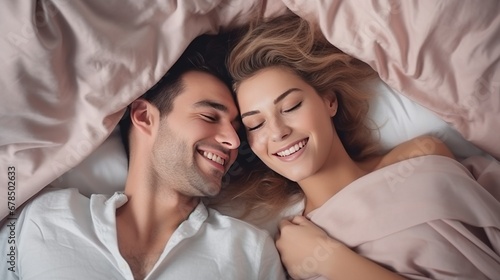 Top view of a very happy 1 young beautiful couple in bed