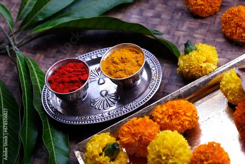 India's tradition Turmeric (Haldi) powder and kumkum powder in silver bowl for pooja. photo