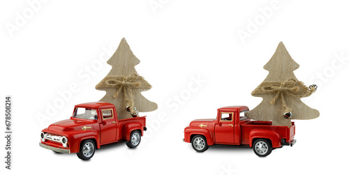 Toy red pickup trucks carry wooden Christmas trees in the back of a white background. Decorative cars for decoration and decor, isolate on white background, red machine