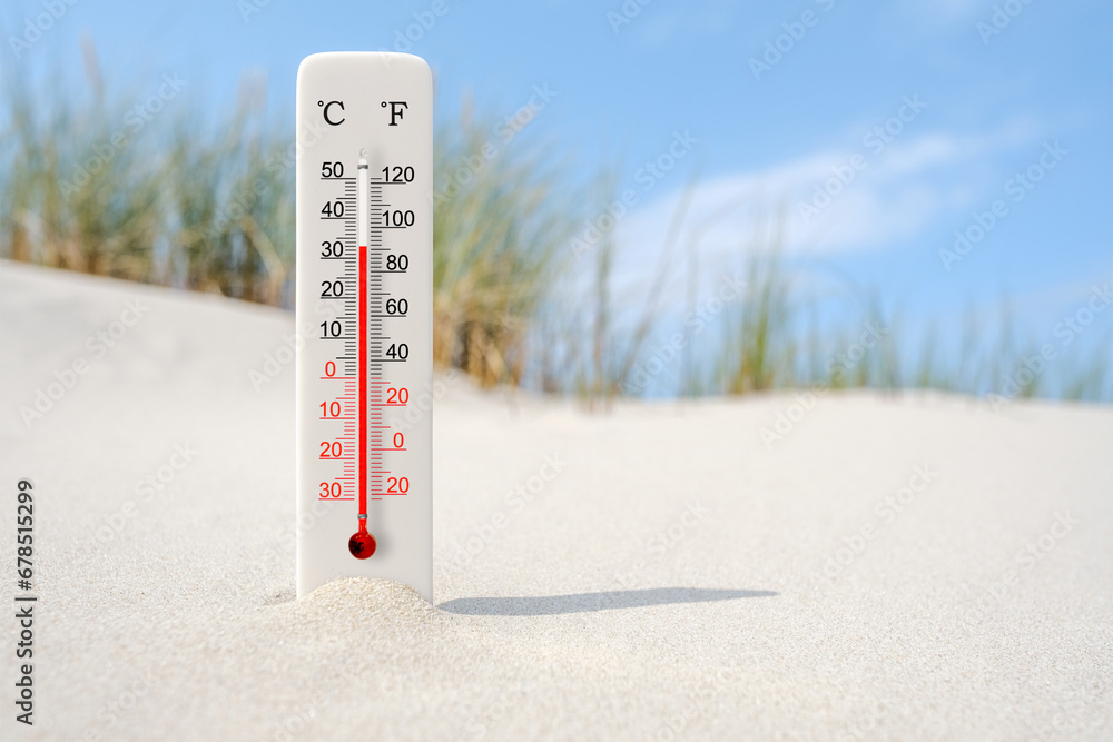 Hot summer day. Celsius and fahrenheit scale thermometer in the sand. Ambient temperature plus 33 degrees - obrazy, fototapety, plakaty 
