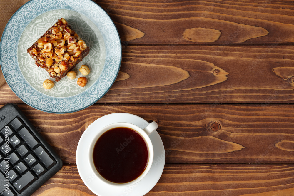 Fototapeta premium Brownie cake with chocolate and hazelnuts on plate