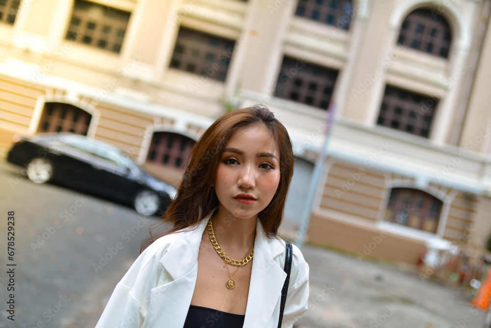 Young woman wearing sunglasses in city, colorful buildings and feel the warm. Exploring this bustling metropolis is a true adventure Young woman wearing sunglasses in city, colorful buildings and feel the warm. Exploring this bustling metropolis is a true adventure