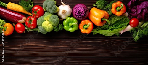 Fresh raw vegetables arranged on a wooden surface from a top view representing healthy eating