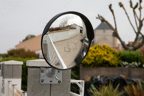 Tableau sur toile Traffic safety convex mirror near exit home portal on the street
