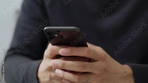 The man is using a smartphone for communication, internet, social networking, and online shopping. Technology concept.