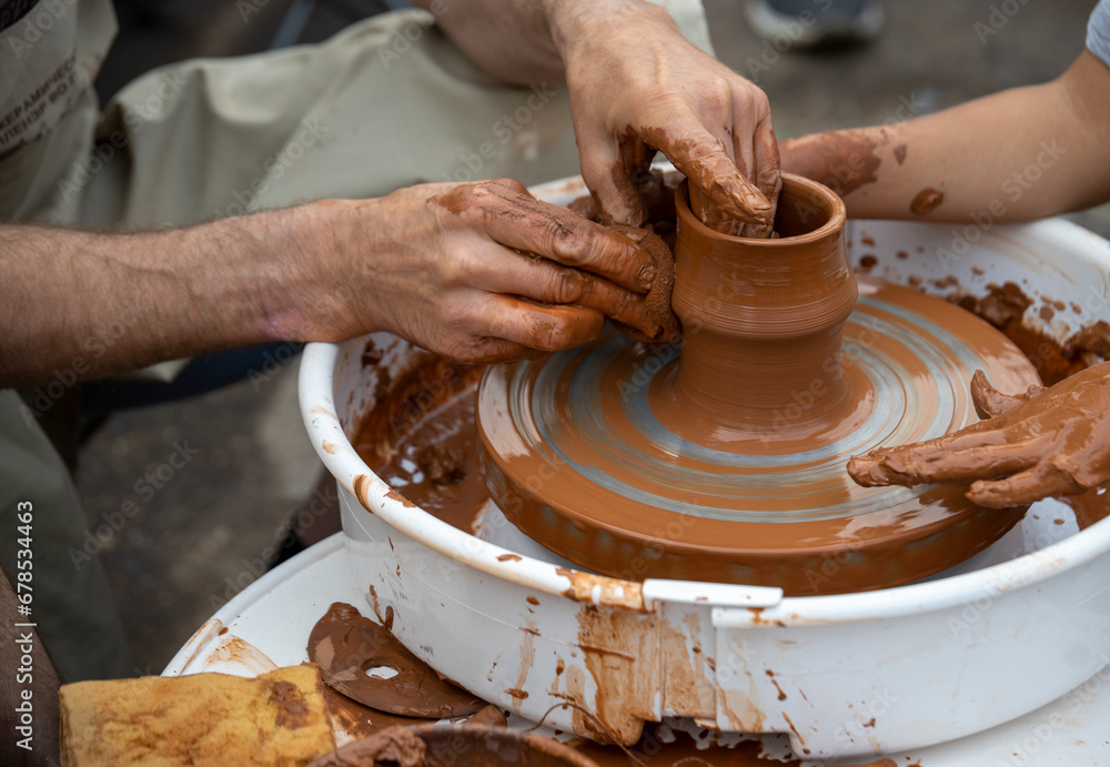 The potter teaches a young student. The potter teaches a young student.