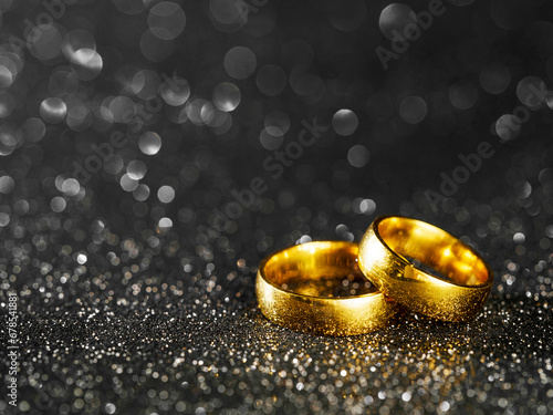 golden rings on black bokeh background 