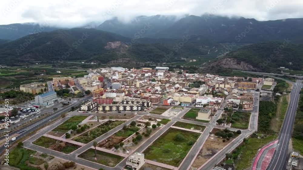 Drone images of Favara, a Spanish town in the province of Valencia surrounded by a mountain range called La Murta and La Casella covered by clouds Drone images of Favara, a Spanish town in the province of Valencia surrounded by a mountain range called La Murta and La Casella covered by clouds