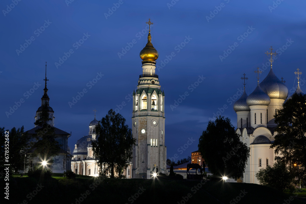 View of the Vologda Kremlin with a bell tower, St. Sophia Cathedral and the Alexander Nevsky Church from the Vologda River at night. Vologda, Russia
