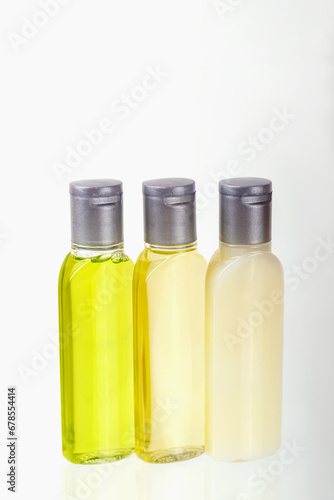 Wallpaper Mural Travel cosmetic set of three small bottles of cosmetics on white background. Shampoo, shower gel, body lotion. Travel, trips, hotels. Cosmetics mockup, advertising. Vertically Torontodigital.ca