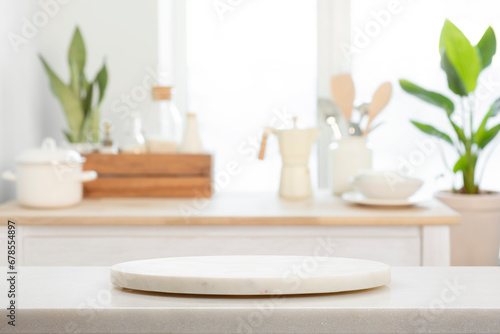 Round pedestal with free space for your decoration on blurred kitchen interior background