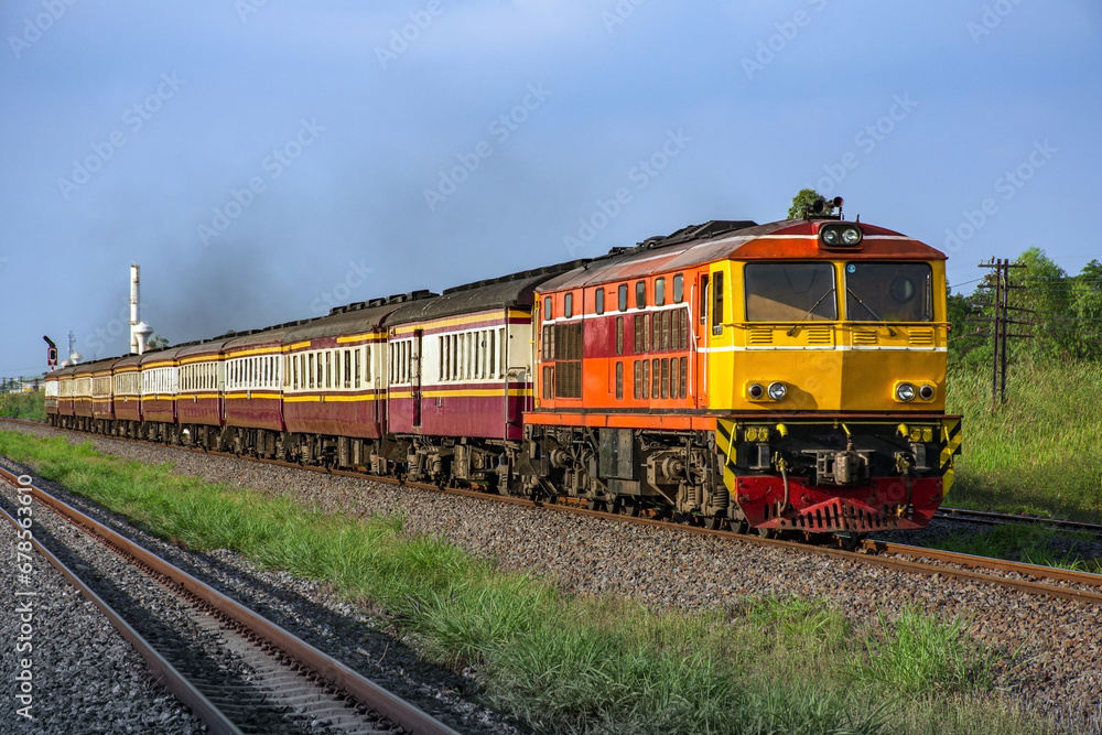 Passenger train by diesel locomotive on the railway.