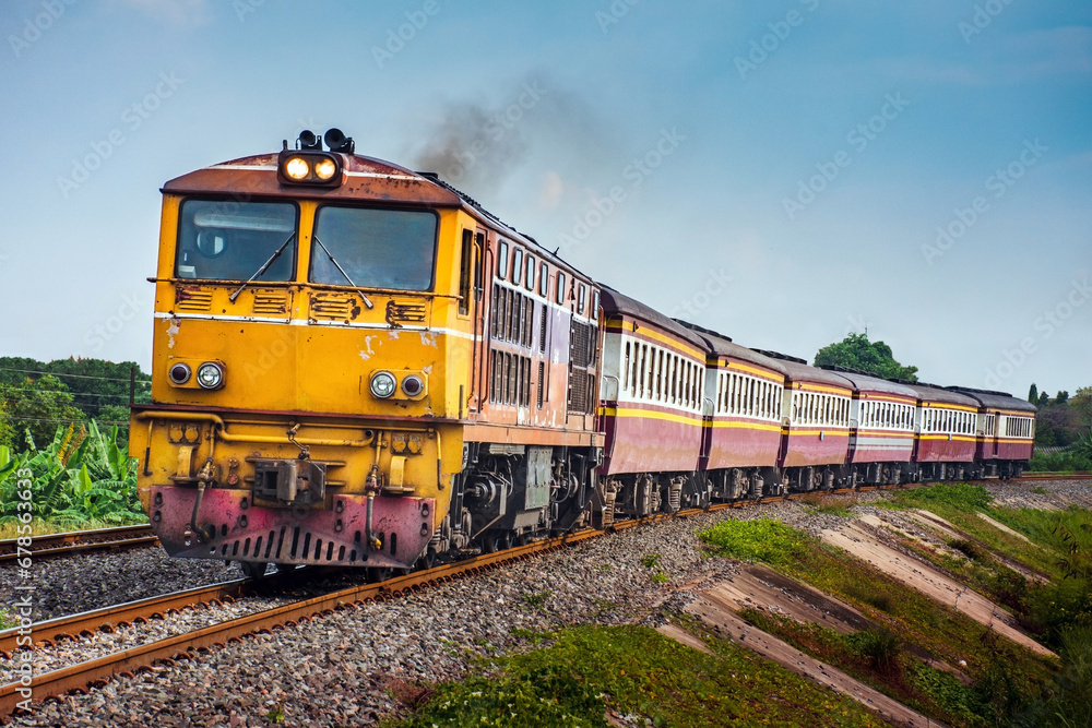 Passenger train by diesel locomotive passed the railway curve.