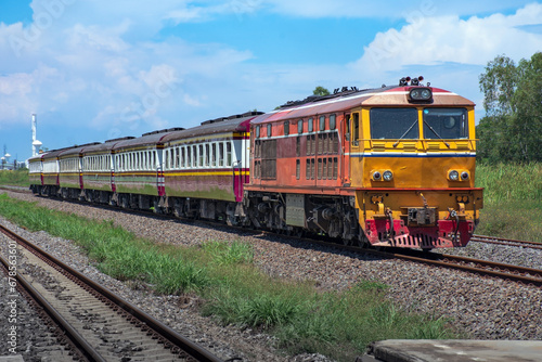 Passenger train by diesel locomotive on the railway.