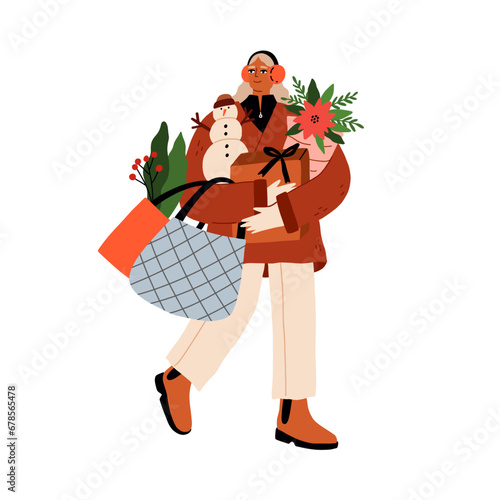 Woman carrying bags and boxes, purchases, winter holiday shopping. Walking wi...
