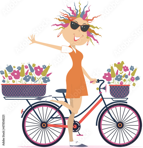 Pretty young cycling woman with bouquets of flowers in the baskets. Cycling woman carries bouquets of flowers in the baskets 
