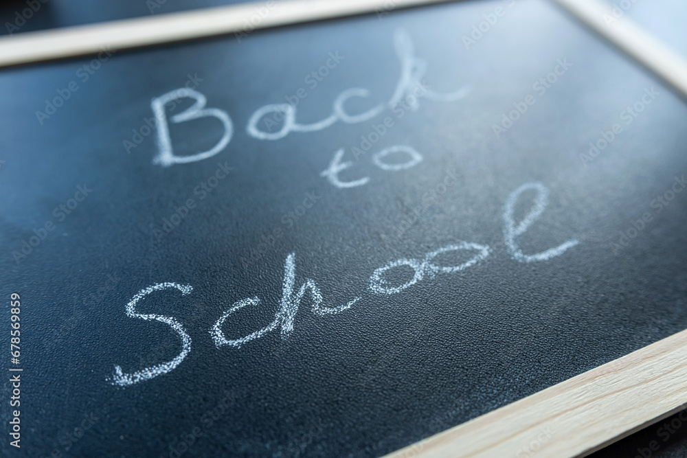 Fototapeta premium Text Back to school soon on blackboard