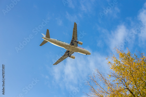 Passenger airplane. Low flying plane on the background of sky. Passenger Airplane Taking Off Into The Blue Sky. Linate Airport. Italia, Lombardia, San Donato Milanese