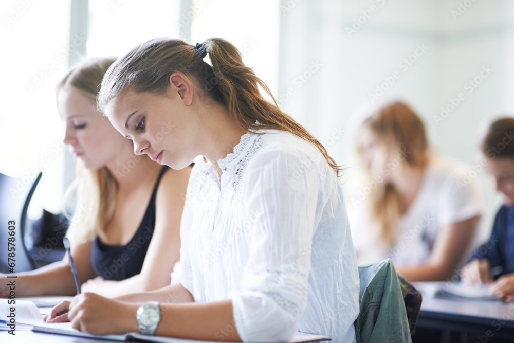College student, writing and learning with notes in class, lecture or people in education. University, classroom and exam or test on campus with knowledge or studying a course in academy or school College student, writing and learning with notes in class, lecture or people in education. University, classroom and exam or test on campus with knowledge or studying a course in academy or school