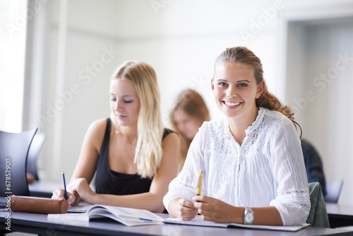 College student, portrait and learning with notes in class, lecture or people in education. University, classroom and face of happy woman with notebook, knowledge and studying in academy or school