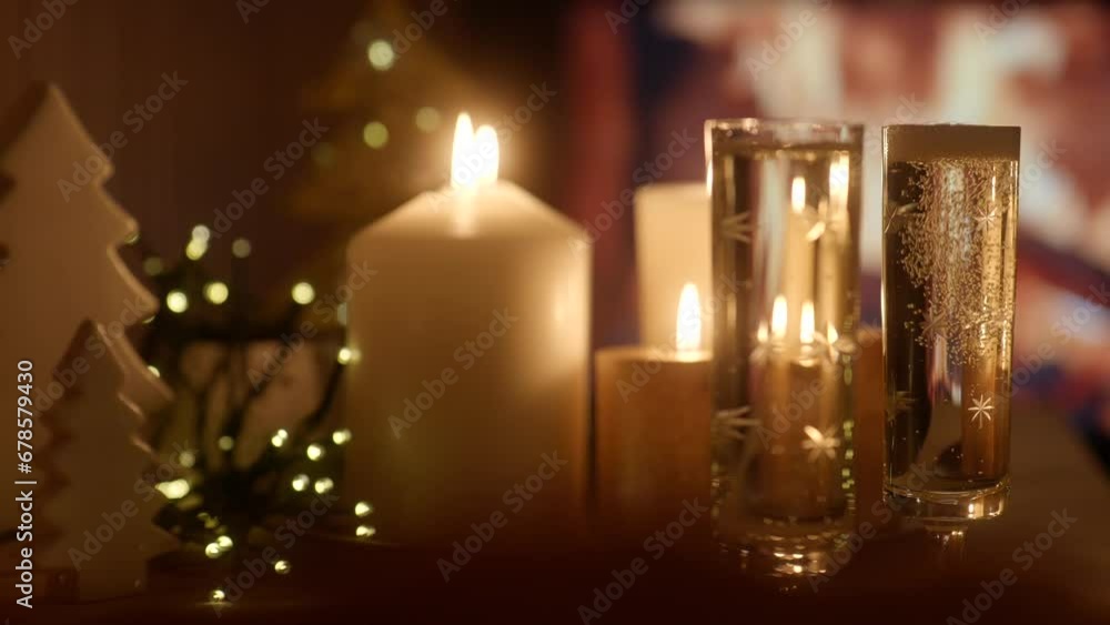 Slow motion of glasses of champagne being filled in front of fireplace and Christmas decoration in 4k Slow motion of glasses of champagne being filled in front of fireplace and Christmas decoration in 4k